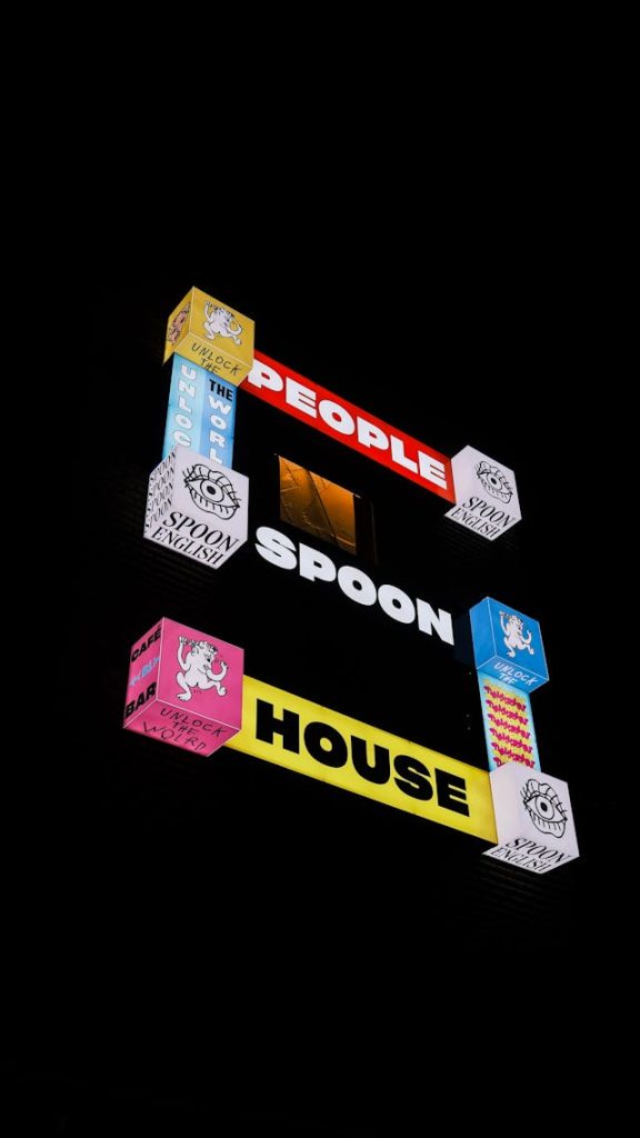 Comparison of a sleek backlit wall sign and a glowing rectangular lightbox storefront sign.