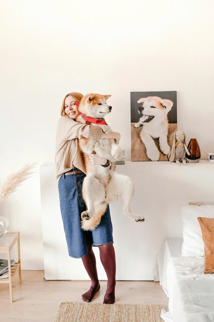 A warm moment between a woman and her pet, captured on a canvas print placed beside her desk.