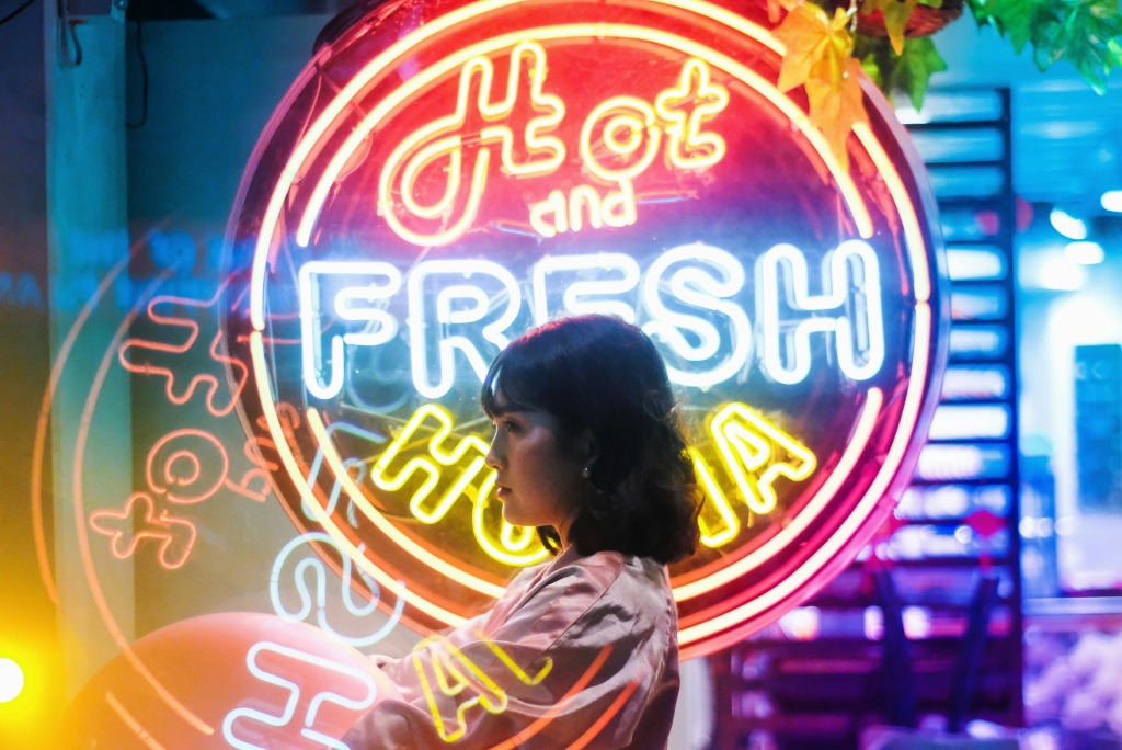 Custom neon sign glowing on a modern storefront wall, creating a bold and artistic brand statement at night.
