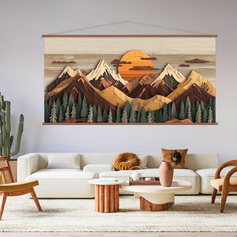 Landscape canvas art featuring mountain silhouettes and a warm sunset in wood tones, hanging in a modern living room interior.
